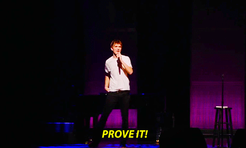 Gif of man on stage throwing glitter saying PROVE IT!