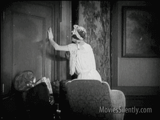 Gif of black and white old time movie of woman fainting