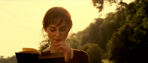 A gif of a Pride and Prejudice character happily reading a book